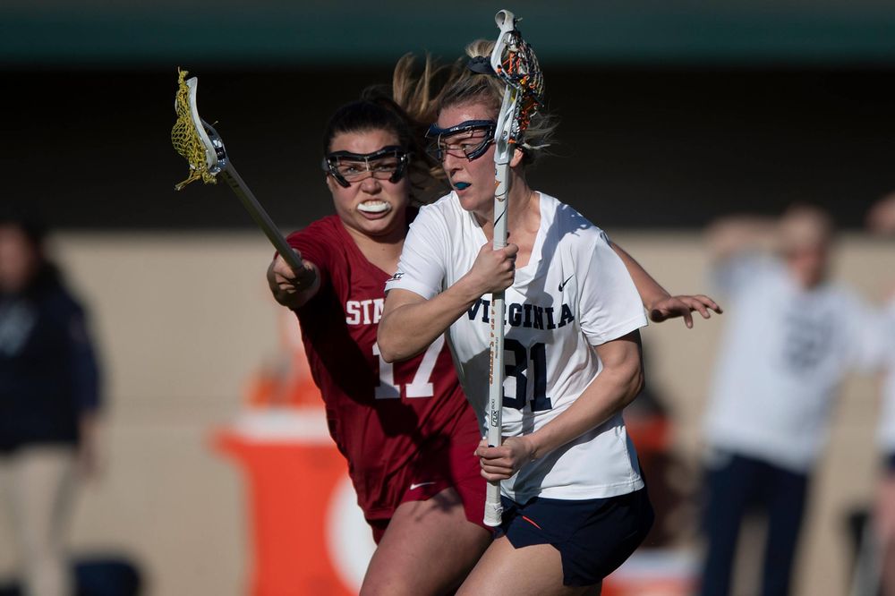 STANFORD, California - FEBRUARY 14:  Virginia Cavaliers defense Ashley Stilo (31) is defended by Stanford Cardinal attack Katherine Gjertsen (17) during the first half at Cagan Stadium on February 14, 2020 in Stanford, California. The Virginia Cavaliers defeated the Stanford Cardinal 12-11. (Photo by Jason O. Watson)