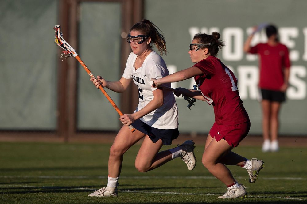 STANFORD, California - FEBRUARY 14:  Virginia Cavaliers midfield Sammy Mueller (2) is defended by Stanford Cardinal midfield Caitlin Chicoski (10) during the second half at Cagan Stadium on February 14, 2020 in Stanford, California. The Virginia Cavaliers defeated the Stanford Cardinal 12-11. (Photo by Jason O. Watson)