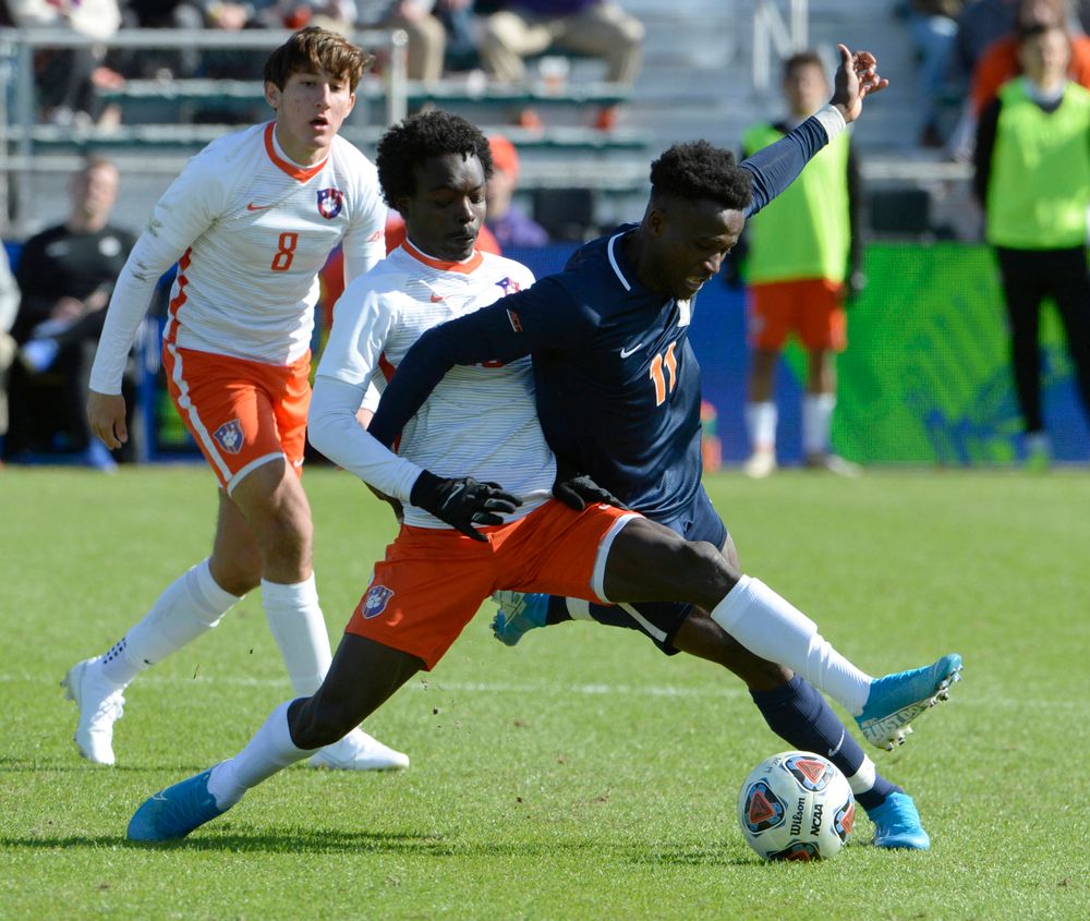 Clemson's Philip Mayaka (20) and Virginia's Irakoze Donasiyano (11) battle for the ball during the 2019 ACC Men?s Soccer Championship at WakeMed Soccer Park in Cary, N.C., Sunday Nov. 17, 2019. (Photo by Sara D. Davis, the ACC)