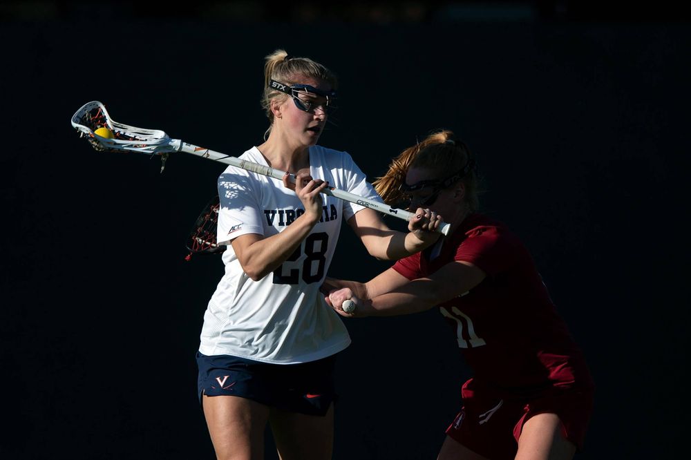 STANFORD, California - FEBRUARY 14:  Virginia Cavaliers midfield Nora Bowen (28) is defended by Stanford Cardinal defense Maggie Bellaschi (11) during the first half at Cagan Stadium on February 14, 2020 in Stanford, California. The Virginia Cavaliers defeated the Stanford Cardinal 12-11. (Photo by Jason O. Watson)