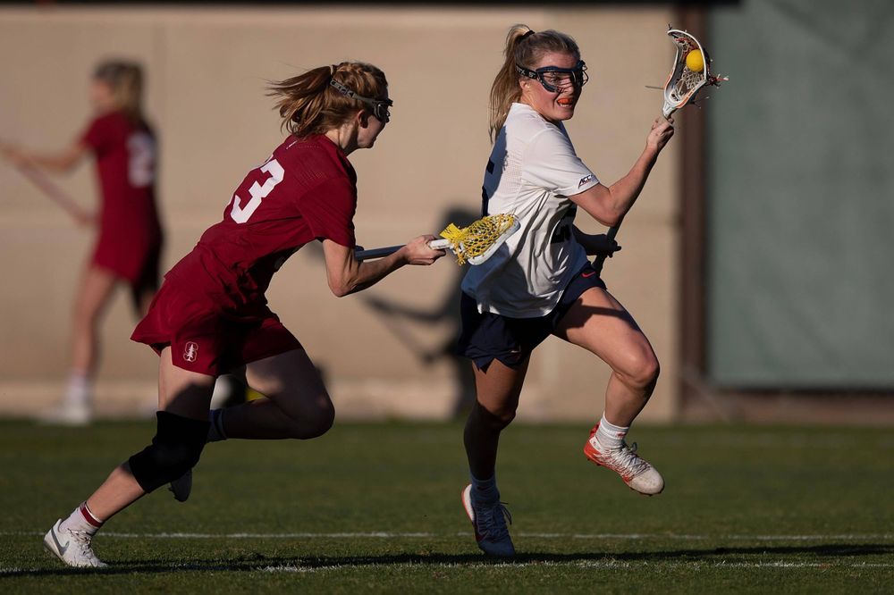 STANFORD, California - FEBRUARY 14: Virginia Cavaliers midfield Courtlynne Caskin (25) is defended by Stanford Cardinal midfield Jacie Lemos (33) during the second half at Cagan Stadium on February 14, 2020 in Stanford, California. The Virginia Cavaliers defeated the Stanford Cardinal 12-11. (Photo by Jason O. Watson)