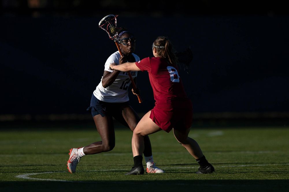 STANFORD, California - FEBRUARY 14: Virginia Cavaliers defense Jalen Knight (12) is defended by Stanford Cardinal defense Kyra Pelton (8) during the second half at Cagan Stadium on February 14, 2020 in Stanford, California. The Virginia Cavaliers defeated the Stanford Cardinal 12-11. (Photo by Jason O. Watson)