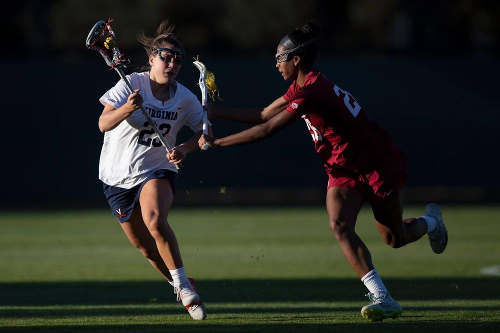 STANFORD, California - FEBRUARY 14:  Virginia Cavaliers midfield Kiki Shaw (23) is defended by Stanford Cardinal midfield Mikaela Watson (26) during the second half at Cagan Stadium on February 14, 2020 in Stanford, California. The Virginia Cavaliers defeated the Stanford Cardinal 12-11. (Photo by Jason O. Watson)