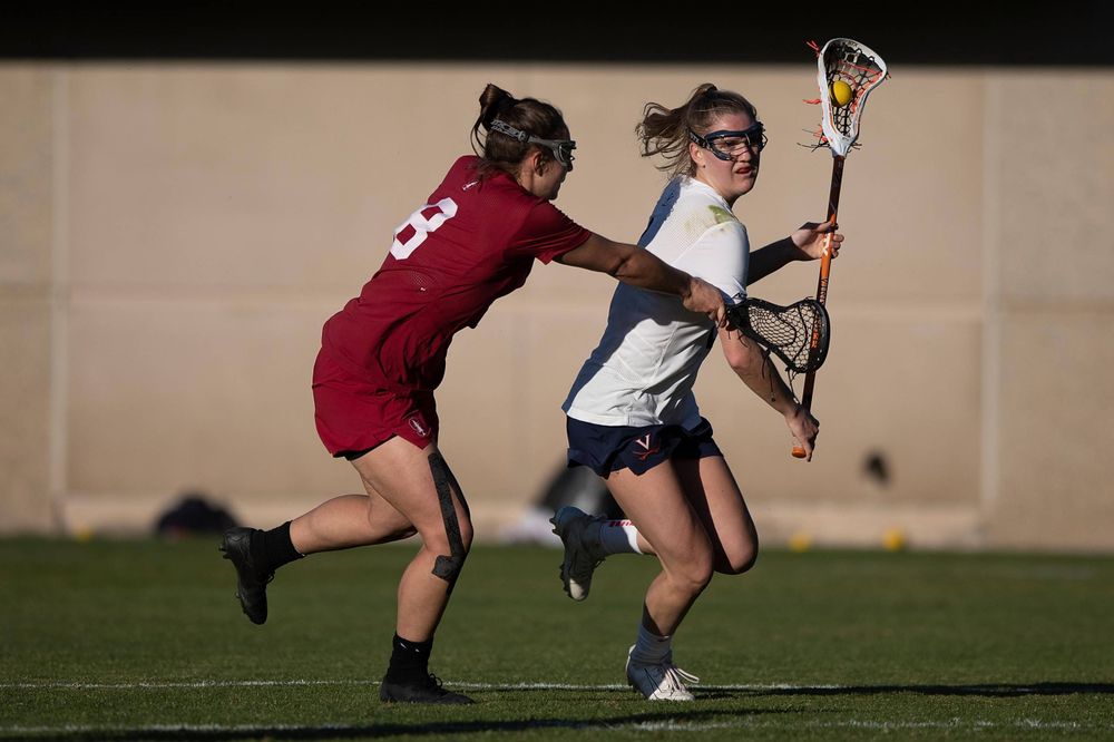 STANFORD, California - FEBRUARY 14:  Virginia Cavaliers midfield Sammy Mueller (2) is defended by Stanford Cardinal defense Kyra Pelton (8) during the second half at Cagan Stadium on February 14, 2020 in Stanford, California. The Virginia Cavaliers defeated the Stanford Cardinal 12-11. (Photo by Jason O. Watson)