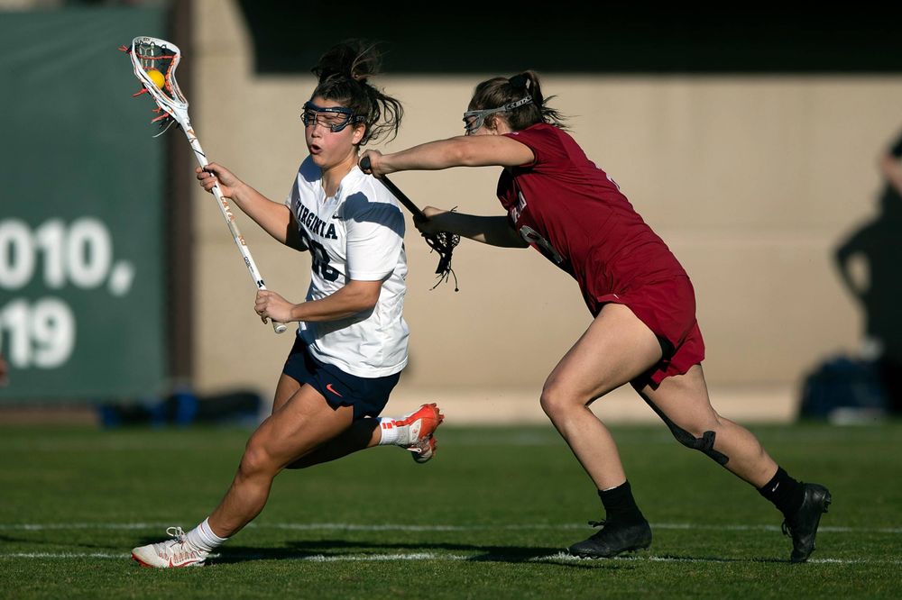STANFORD, California - FEBRUARY 14:  Virginia Cavaliers midfield Kiki Shaw (23) is defended by Stanford Cardinal defense Kyra Pelton (8) during the first half at Cagan Stadium on February 14, 2020 in Stanford, California. The Virginia Cavaliers defeated the Stanford Cardinal 12-11. (Photo by Jason O. Watson)