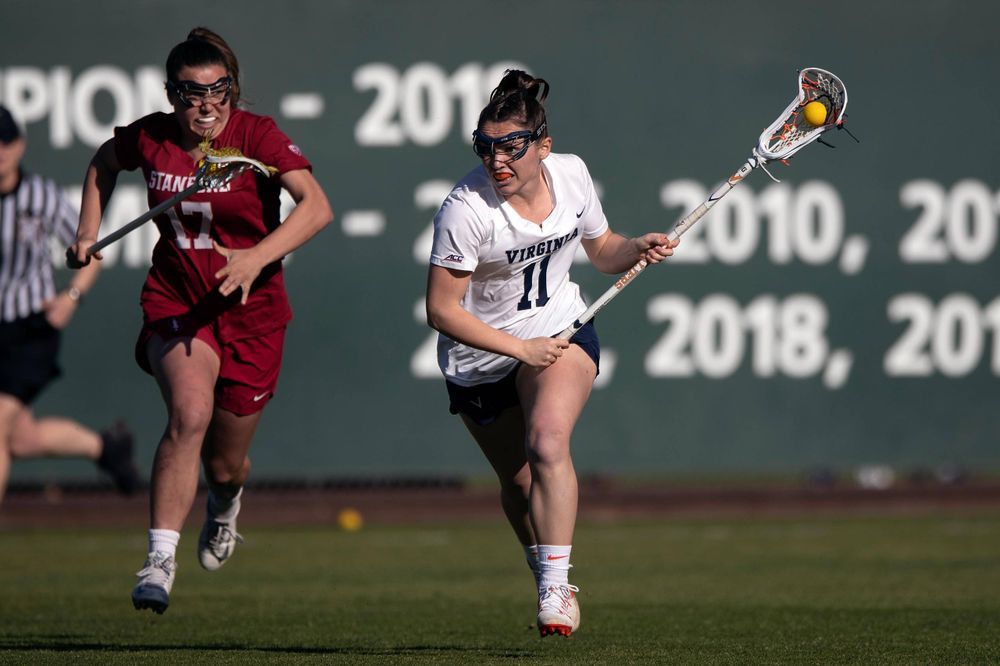 STANFORD, California - FEBRUARY 14:  Virginia Cavaliers midfield Halle Graham (11) runs up field past Stanford Cardinal attack Katherine Gjertsen (17) during the first half at Cagan Stadium on February 14, 2020 in Stanford, California. The Virginia Cavaliers defeated the Stanford Cardinal 12-11. (Photo by Jason O. Watson)
