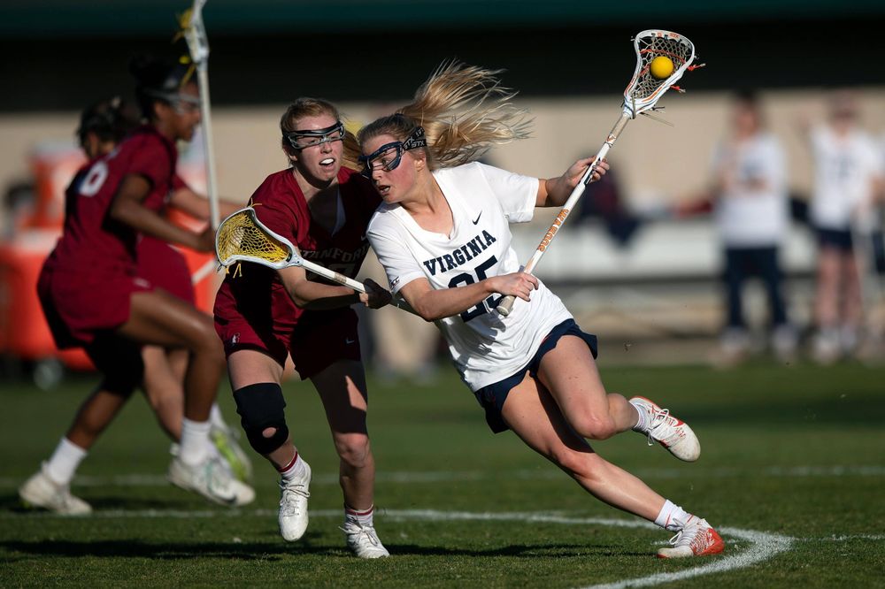 STANFORD, California - FEBRUARY 14:  Virginia Cavaliers midfield Courtlynne Caskin (25) is defended by Stanford Cardinal attack Kelleigh Keating (23) during the first half at Cagan Stadium on February 14, 2020 in Stanford, California. The Virginia Cavaliers defeated the Stanford Cardinal 12-11. (Photo by Jason O. Watson)