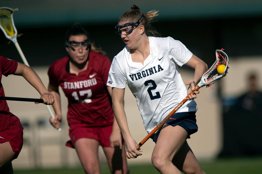 STANFORD, California - FEBRUARY 14:  Virginia Cavaliers midfield Sammy Mueller (2) carries the ball past Stanford Cardinal attack Katherine Gjertsen (17) during the first half at Cagan Stadium on February 14, 2020 in Stanford, California. The Virginia Cavaliers defeated the Stanford Cardinal 12-11. (Photo by Jason O. Watson)